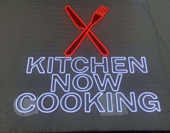 Kitchen Now Cooking neon sign with crossed fork and knife
