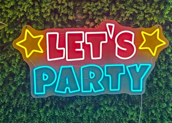 Multicoloured neon sign reading Let's Party with stars