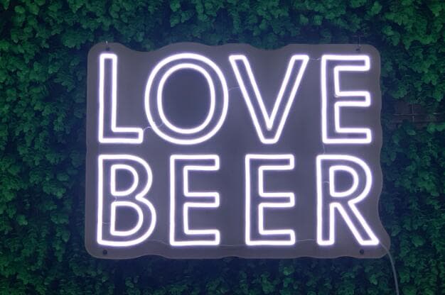 White neon sign reading Love Beer